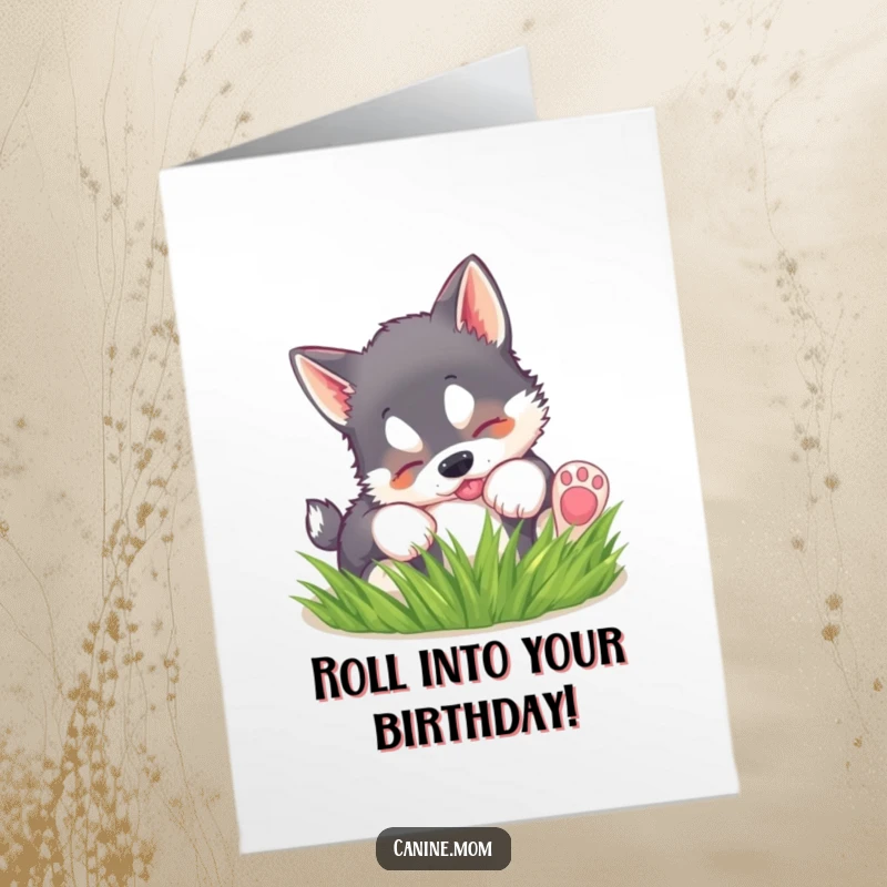 Funny free printable birthday card: A fluffy husky puppy joyfully rolls in soft green grass, full of playful energy.